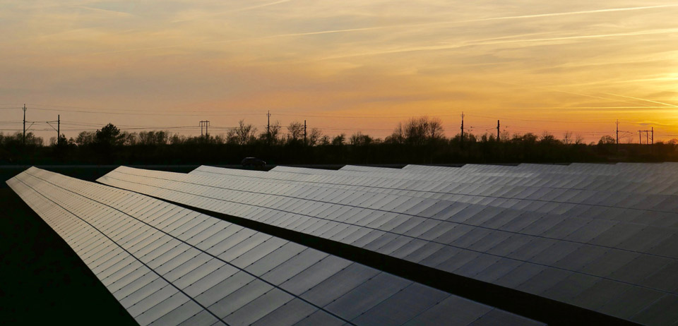 View of solar panel rows in sunset